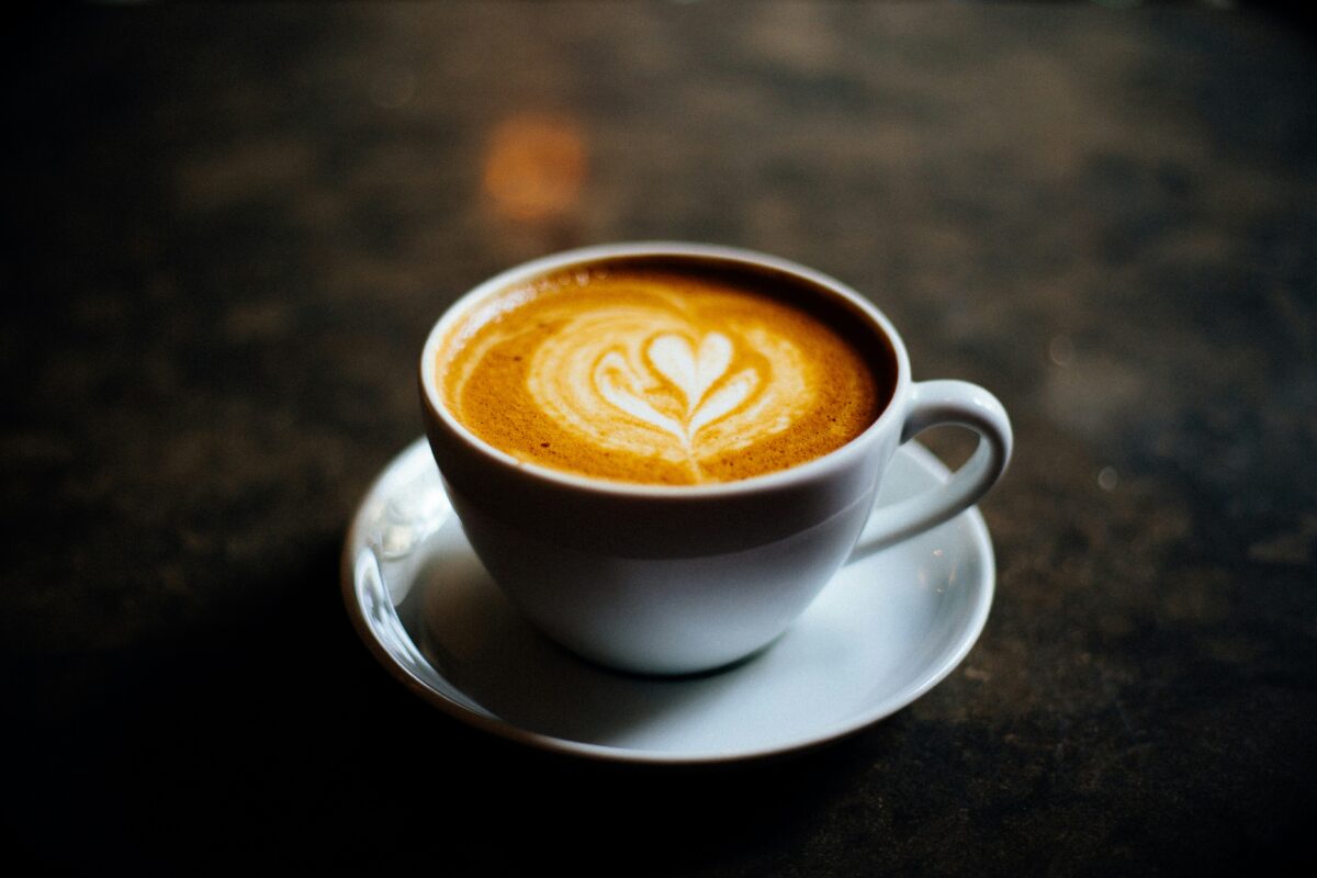 Best coffee beans 2025: The image shows a creamy cup of coffee on a table.